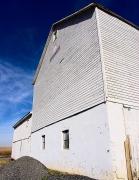 White Building, Blue Skies, a Pile of Gravel